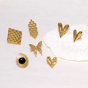 Detail view of assorted gold stainless steel rings with heart, butterfly and geometric designs