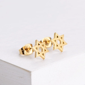 Minimalist gold stainless steel hexagram stud earrings displayed on a white stone base