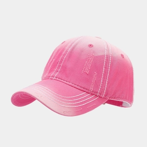 Detailed view of pink distressed cotton baseball cap with white contrast stitching