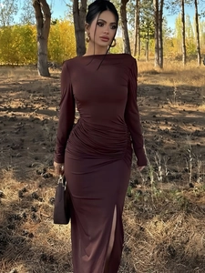 Detail view of the ruched waist design and side slit on this dark brown slim dress