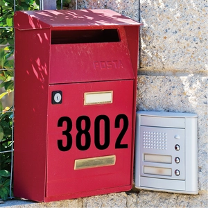 Outdoor 6-inch black number 3802 sticker on a red metal mailbox with stone wall
