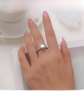 Detail view of S925 sterling silver ring featuring a large round rainbow opal gemstone