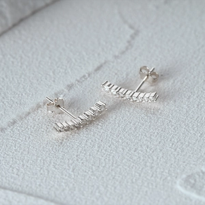 Macro shot of S925 sterling silver half moon earrings with zircon inlay and hallmark