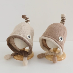 Winter knitted earflap hat for kids with penguin patch and playful long tail top
