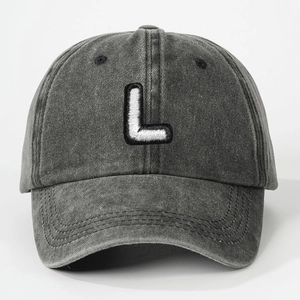 Detailed close-up of premium white embroidered letter L on vintage dark gray washed cotton cap