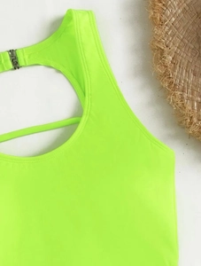 Close-up of neon green bikini with open back design and silver metal buckle detail