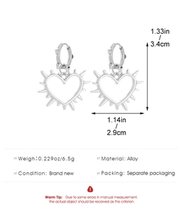 Macro detail of silver thorn heart earrings showing dimensions 3.4cm by 2.9cm and punk style