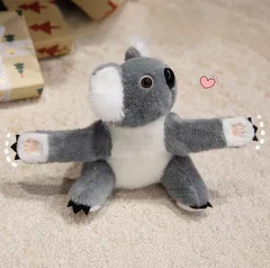 Detailed view of grey plush koala slap bracelet toy with open arms on a soft carpet