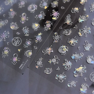 Iridescent shell light nail stickers with snowflake and bubble patterns on black backing