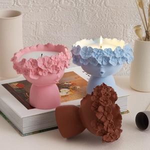 Detailed view of floral crown girl portrait candle holders in various pastel finishes