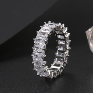 Close-up of hip hop style ring featuring rectangular zircon stones and silver finish