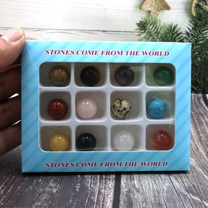 Macro detail of natural stone sphere set in a striped blue window gift box