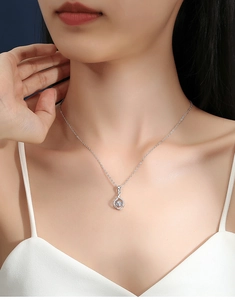 Detail of a S925 sterling silver heartbeat necklace with a dancing moissanite pendant