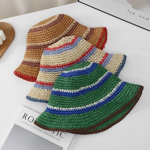 Handmade striped straw bucket hats with wide brims for sun protection in summer