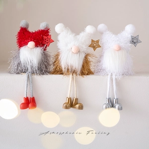 Three Christmas Santa gnomes with knitted hats and wooden stars for holiday home decoration