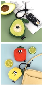 Detail of fruit-shaped corduroy pendants featuring avocado, carrot and lemon embroidery
