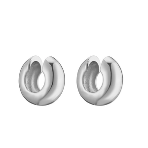 Detailed macro view of polished silver C-shaped ear cuffs with multi-layer ribbed design
