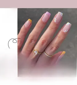 Close-up of pink translucent press-on nails with white flowers and yellow French tips