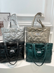 Quilted space cotton tote bag in silver, gold, black, and green with fashion label