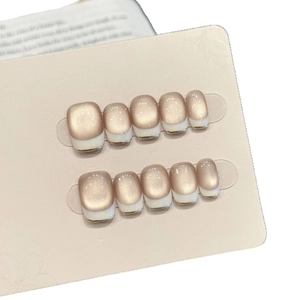 Short square champagne cat-eye press-on nails with white French tips and gold lines