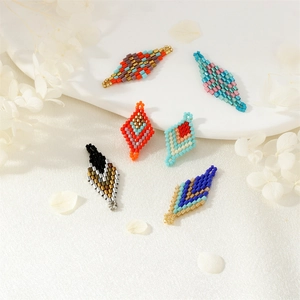 Handmade rhombus bead earrings accessories in colorful mosaic patterns on white background