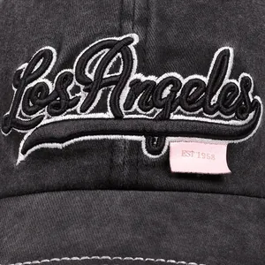 Detail of Los Angeles embroidery on washed denim baseball cap with pink leather patch