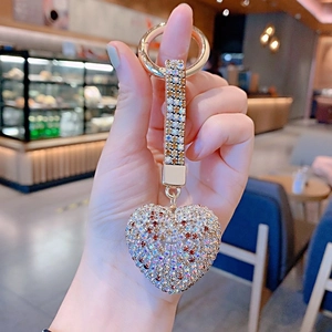 Detailed view of heart-shaped keychain with pavé colorful rhinestones and gold ring