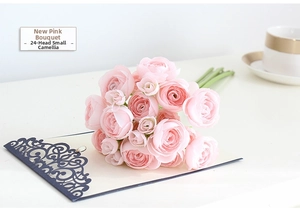 Pink artificial camellia silk flower bouquet with 24 heads on a white table setting