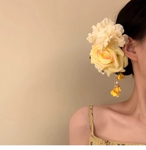 Detailed view of the large fabric rose hair clip with elegant pearl tassels for women