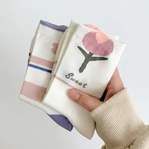 Detailed texture of cotton socks with embroidered tulips and Akesu long-staple cotton