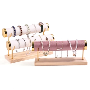 Golden 4-tier wood jewelry stand for displaying bracelets and watches in white and purple