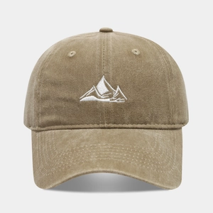 Close-up of the vintage washed cotton texture and white mountain embroidery on the khaki cap