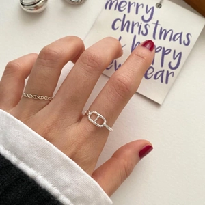 Detailed view of sterling silver Chaine d'Ancre style rings on model fingers