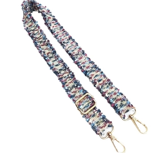 Adjustable woven shoulder strap for bags with colorful textile pattern and gold metal hooks