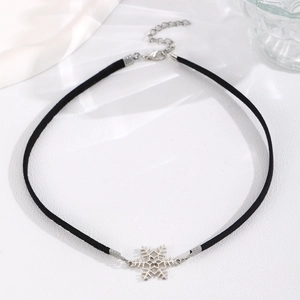 Detail of black velvet choker with silver snowflake pendant and adjustable metal chain link