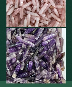 Macro view of assorted hexagonal pink rose quartz and purple amethyst energy crystal points