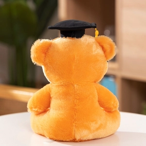 Rear view of orange plush graduation bear showing high quality stitching and black cap