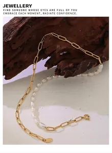 Detail of 18K gold clip chain and baroque pearl necklace with K18 engraved tag