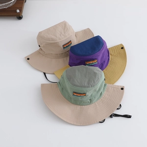 Three outdoor sun hats for kids in beige and color block designs with windproof straps