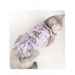 Detailed view of purple cat recovery suit featuring sweet bows and ribbed fabric texture