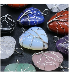 Detail of tree of life wire-wrapped heart crystal pendants in various natural stones