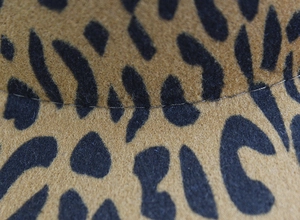 Macro detail of leopard print wool felt hat showing high-quality stitching and texture