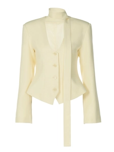 Detail of slim-fit beige blazer featuring a stylish neck scarf and four matching buttons