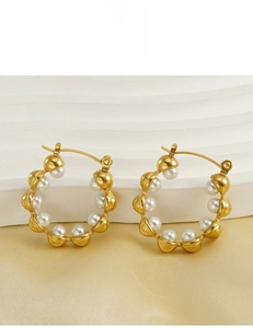 Detailed view of 18k gold plated titanium steel hoop earrings with inset white pearls