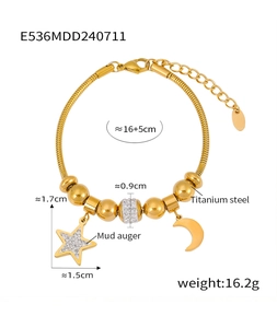 Detail of gold star moon charms and rhinestone beads on titanium steel bracelet