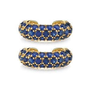 Detailed view of gold C-shaped ear cuffs pave-set with two rows of deep blue zircons