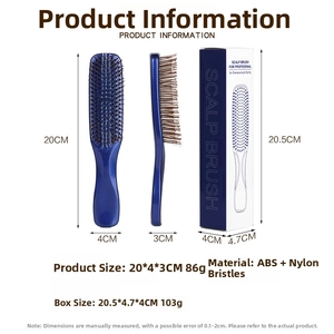 Detail view of navy scalp massage brush with nylon pins and branded packaging box