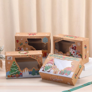 Christmas kraft paper gift boxes with windows and festive prints on a wooden surface