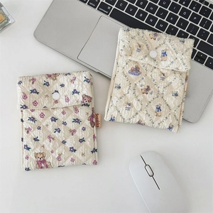 Close-up of quilted floral sanitary pads bags with cute bear and rabbit patterns