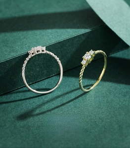 Macro detail of 925 sterling silver twisted rings with three brilliant round zircons